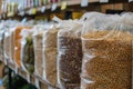 Sacks filled with colorful legumes beautifully displayed at a market, offering variety and healthful options