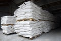 Sacks of flour and grain are stacked in neat rows in the farm\'s warehouse. Royalty Free Stock Photo