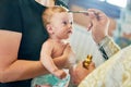 The sacrament of baptism. Newborn baby during christening and chrismation Royalty Free Stock Photo