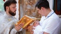 The sacrament of baptism. Christening the baby. Child, priest and godfather