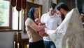 The sacrament of baptism. Christening the baby. Child, priest and parishioners