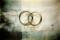 Sacrament: Matrimony. Two golden wedding rings on grunge background