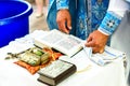 The sacrament of the rite baptism of a child in an Orthodox Christian church. Chan for ablution and altar with a bible