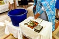 The sacrament of the rite baptism of a child in an Orthodox Christian church. Chan for ablution and altar with a bible Royalty Free Stock Photo