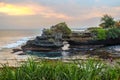 Sacred Balinese temple Tanah Lot. Pura Batu Bolong on the edge of a cliff at coastline with hole in rock