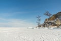 Sacred Cape Burkhan on Olkhon Island in winter. View from the ice of frozen Lake Baikal on a sunny day