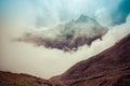 The Sacred Fishtail Mountain revealing through high clouds. Anna Royalty Free Stock Photo
