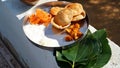 Sacred food on a leaf for the crow bird to eat. Food placed on a green leaf during a Hindu Ritual in the