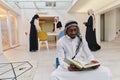 In the sacred month of Ramadan, an African American Muslim man engrossed in reading the Holy Quran is surrounded by a