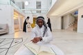 In the sacred month of Ramadan, an African American Muslim man engrossed in reading the Holy Quran is surrounded by a