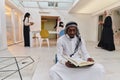 In the sacred month of Ramadan, an African American Muslim man engrossed in reading the Holy Quran is surrounded by a