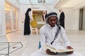 In the sacred month of Ramadan, an African American Muslim man engrossed in reading the Holy Quran is surrounded by a