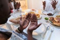 In the sacred month of Ramadan, a diverse Muslim family comes together in spiritual unity, fervently praying to God