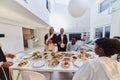 In the sacred month of Ramadan, a Muslim family joyously comes together around a table, eagerly awaiting the communal