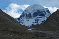 Sacred mountain Kailash peak against white clouds and blue sky Royalty Free Stock Photo