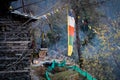 sacred religious multicolored prayer flags old and tattered torn outside wooden cabin in bhuddist prayer incantation