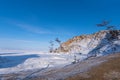 Sacred Shamanka Mountain on Olkhon Island in winter. View of the frozen Lake Baikal on a sunny day