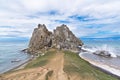 A sacred Shamanka rock against the backdrop of a dramatic sky and stormy lake. Cape Burkhan, Olkhon Island, Lake Baikal