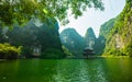 Sacred temple in the middle of the river, surrounding by limestone cliff