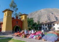 Colorful Spanish church and market place in Yucay, Peru.