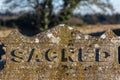 Sacred. The word sacred written on an ancient grave stone