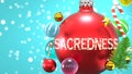 Sacredness and Xmas holidays, pictured as abstract Christmas ornament ball with word Sacredness to symbolize the connection and