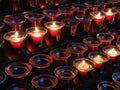 Sacrificial candles that believers light in a Catholic church in front of the altar Royalty Free Stock Photo