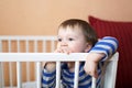 Sad 1 year baby in white bed Royalty Free Stock Photo