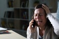 Sad adult woman calling on phone crying at night at home Royalty Free Stock Photo