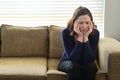 Sad adult woman forced to stay at home as the pandemic coronavirus COVID-19 forces many people to stay at home because new Royalty Free Stock Photo