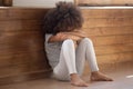 Upset biracial preschooler girl cry sitting on floor Royalty Free Stock Photo