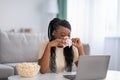 Sad african american woman weeping while watching soap opera Royalty Free Stock Photo