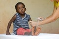 Sad African boy ready to get an injection from a volunteer nurse in Bamako, Mali Royalty Free Stock Photo