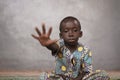 Sad African Boy Shows Stop Symbol with Hand