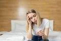 Sad one woman complains about pregnancy test sitting on sofa in living room at home, frustrated with results