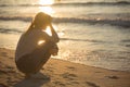 Sad and alone young woman at the beach. Royalty Free Stock Photo