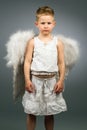 Sad angel kid with white wings Royalty Free Stock Photo