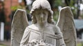 sad angel sculpture in cemetery