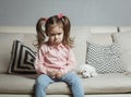 Sad or angry little girl, victim, holding toy dog. Royalty Free Stock Photo