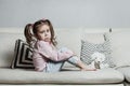 Sad or angry little girl, victim, holding toy dog. Royalty Free Stock Photo