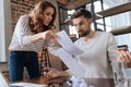 Sad angry woman showing documents to her boyfriend Royalty Free Stock Photo