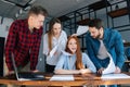 Sad angry young business woman under stress throwing documents sitting at desk looking at camera, multiethnic colleagues Royalty Free Stock Photo