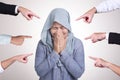 Sad anxious Asian muslim woman judged by different hands. Concept of accusation of guilty girl