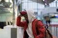 Sad african man standing near check-in desk feeling frustrated because of flight cancellation