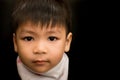 Sad Asian boy portrait on black. Royalty Free Stock Photo