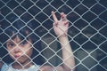 Sad Asian girl child alone in cage was imprisoned make no freedom or lack of freedom