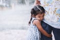 Sad asian little girl hugging her mother leg Royalty Free Stock Photo