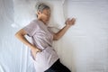 Sad asian senior woman touching hip on her bed,problem of pain while sleep feel backache discomfort,female old elderly suffering