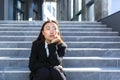 Sad asian woman fired from work sitting on the stairs Royalty Free Stock Photo