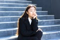 Sad asian woman fired from work sitting on the stairs Royalty Free Stock Photo